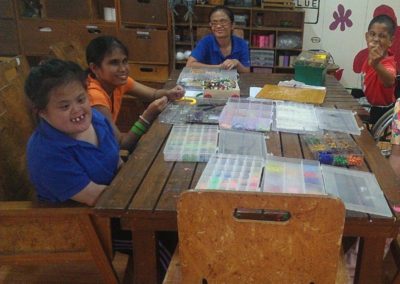 Children with special needs doing sitting around an arts and crafts table